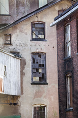 Architectural detail of walls and windows in the historic Hockanum and Dart's Stone Mill complex in Rockville, Connecticut.