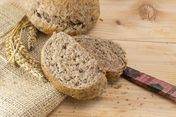 Home baked brown bread slices on wooden table