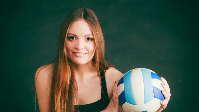 Young woman wear sportswear and hold ball.