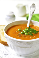 Carrot creamy soup with green pea.