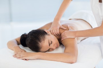 Fototapeta na wymiar Relaxed naked woman receiving back massage