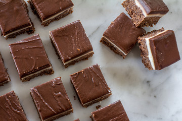 Chocolate Peppermint Slice Cut Up on Marble Cutting Board from Above