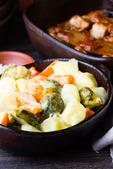 Rustic baked vegetables in clay bowl