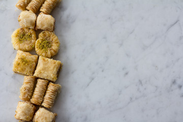 Row of Baklava on Marble Background From Above with Copy Space