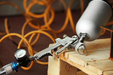 Spray gun on wooden stand, closeup