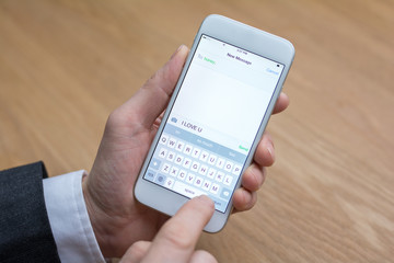 businessman edits message on mobile phone