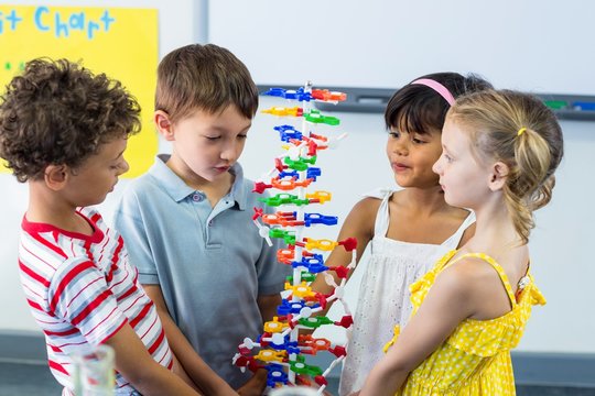 Schoolchildren holding DNA model  - Powered by Adobe
