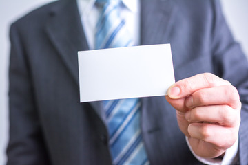 businessman holding white blank paper