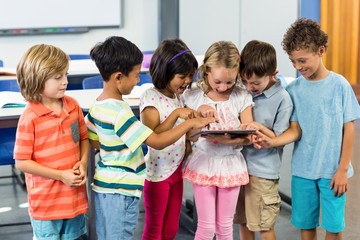 Schoolchildren using digital tablet
