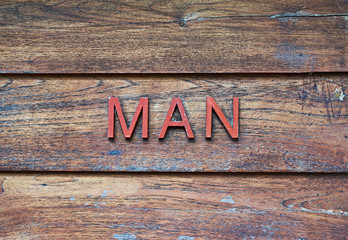 MAN word on wooden table in vintage style.