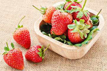Strawberry in a wooden bowl.