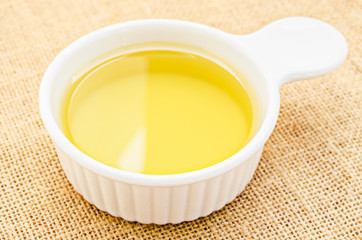 Vegetable oil in white cup.