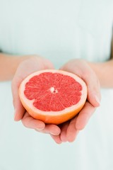 Woman holding grapefruit