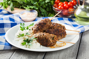Barbecued kofta with rice on a plate