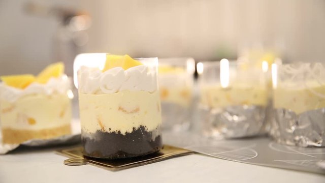 Chef hand decorated mango cheese cake with chocolate tart