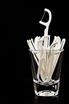 Dental Floss toothpick in glass.