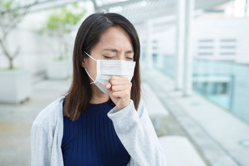 Woman feeling sick and wearing face mask