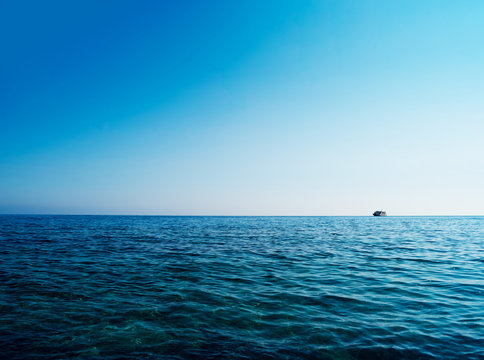 Horizontal blue ocean ship on horizon background