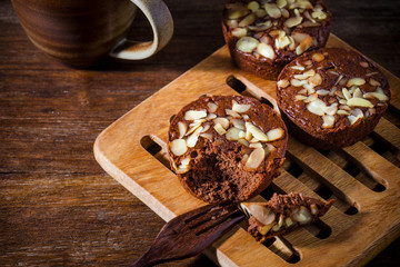 Homemade delicious fresh chocolate and almonds cake on wooden