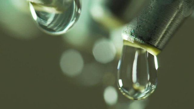 slow motion macro water dripping from corroded shower head