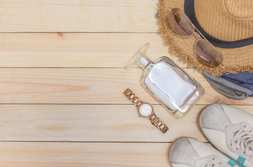 Overhead view of traveler's casual outfits, Travel accessories and costume on wooden background