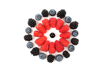 raspberries, blackberries, blueberries laid out in the shape of