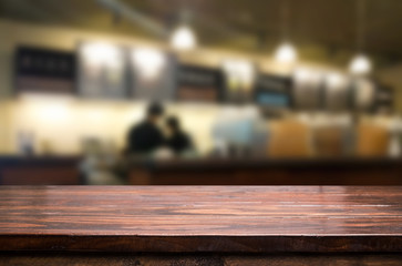 Selected focus empty brown wooden table and Coffee shop restaura