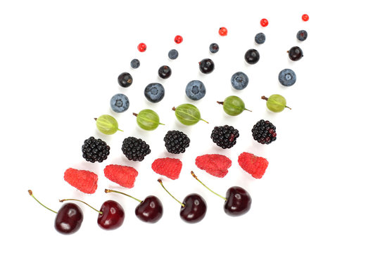 different juicy berries are laid out in rows on a white background