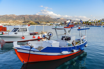 Naklejka na ściany i meble Beautiful fishing boat staing parked at harbour of Sitia town on Crete island, Greece