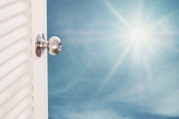 Door opening with blue sky and shiny sunshine, dreamy concepts