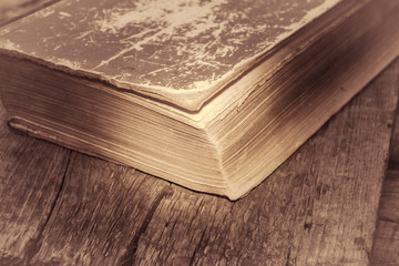 Old books on wooden table. Color toned.