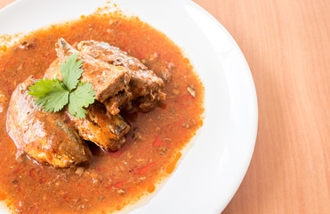 Mackerel in Tomato Sauce on wooden background