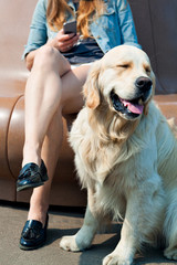 Young woman and her dog golden retriever in the park