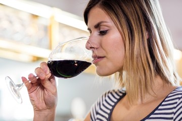 Young woman drinking wine at restaurant