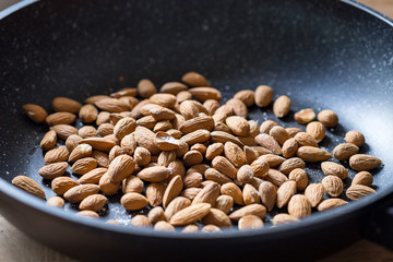 Almonds with Salt in Black Pan, Close-up View