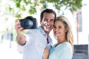 Couple with camera at street 