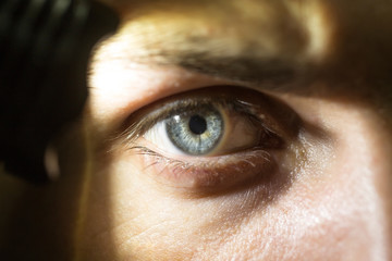 male eye with flashlight