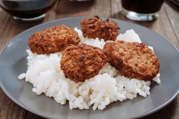 fried meat balls over rice in gray earthenware
