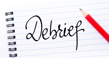 Debrief written on notebook page