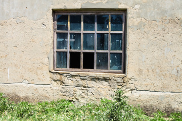 Fototapeta na wymiar window in wall of abandoned building