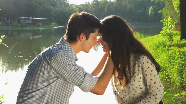 Young loving couple kissing in the park