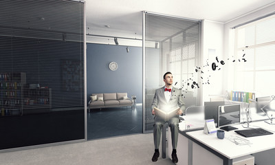 Businessman reading old book . Mixed media