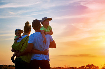 happy family at sunset. father, mother and two children - 115291184