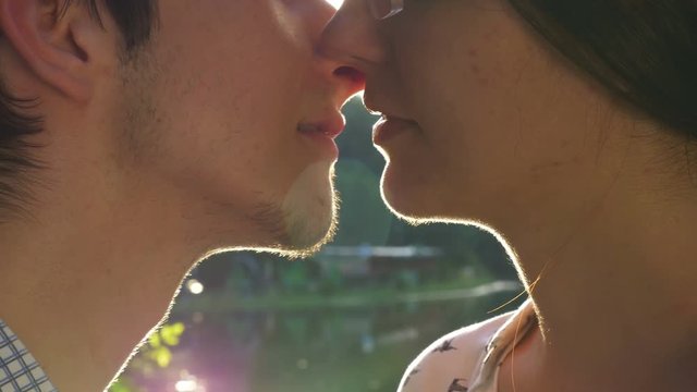 Close-up of loving couple kissing at sunset