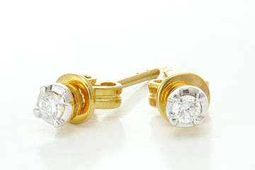 Gold earring on white background