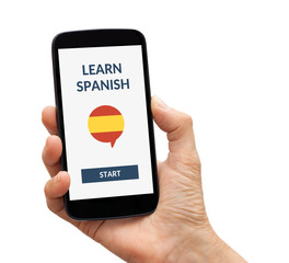Hand holding smart phone with online learn spanish concept on screen. Isolated on white. All screen content is designed by me