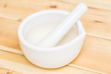 herbal mortar on wood background.