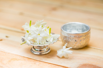 Obraz na płótnie Canvas water in silver bowl with jasmine white flower, Thailand Songkarn