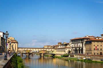 Fototapeta premium View of medieval stone bridge Ponte Vecchio and the Arno River from the Ponte Santa Trinita in Florence, Tuscany, Italy. Florence is a popular tourist destination.