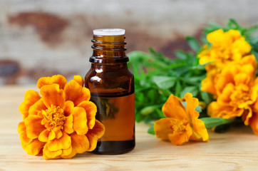 Small bottle of essential marigold oil (Tagetes flowers extract, tincture, infusion)